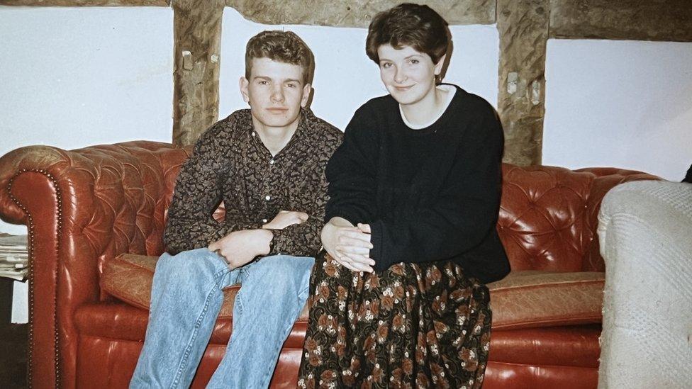 Joanna Parrish and her brother Barney sitting on a sofa