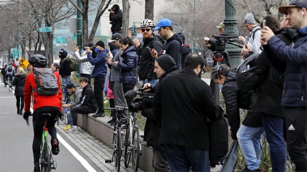 New Yorkers watch arrival in New York Harbour of US Naval Ship Comfort (30/03/20)