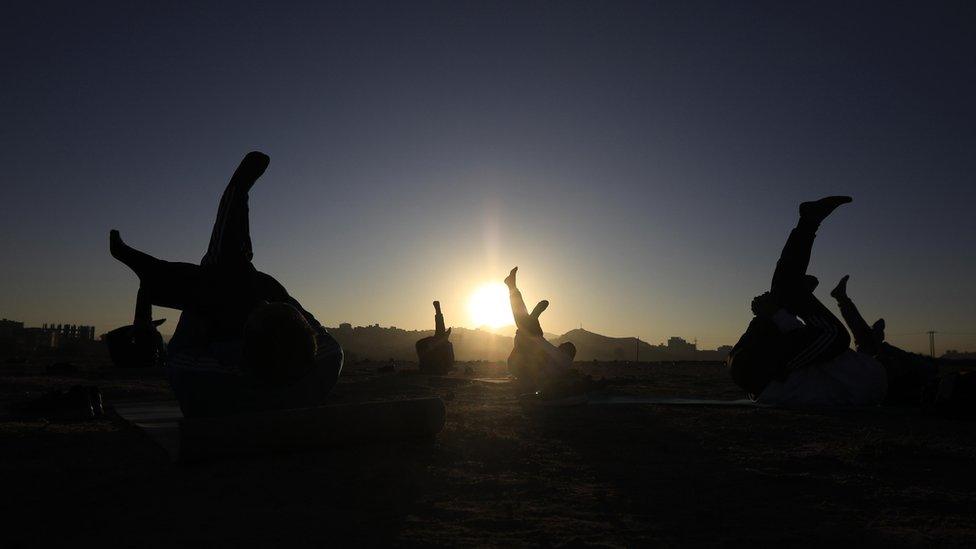 People perform workouts during sunrise on the first day of 2024, in Sana'a, Yemen