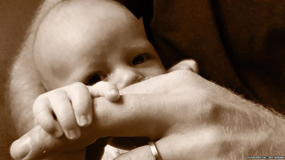 Archie grabbing his dad Prince harry's hand.