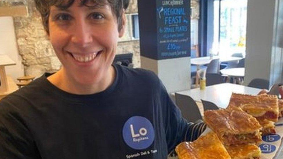 Staff member holding a tray of food