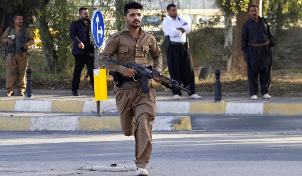 A member of peshmerga forces runs at a site of an attack by Islamic State militants in Kirkuk, Iraq, October 21, 2016.