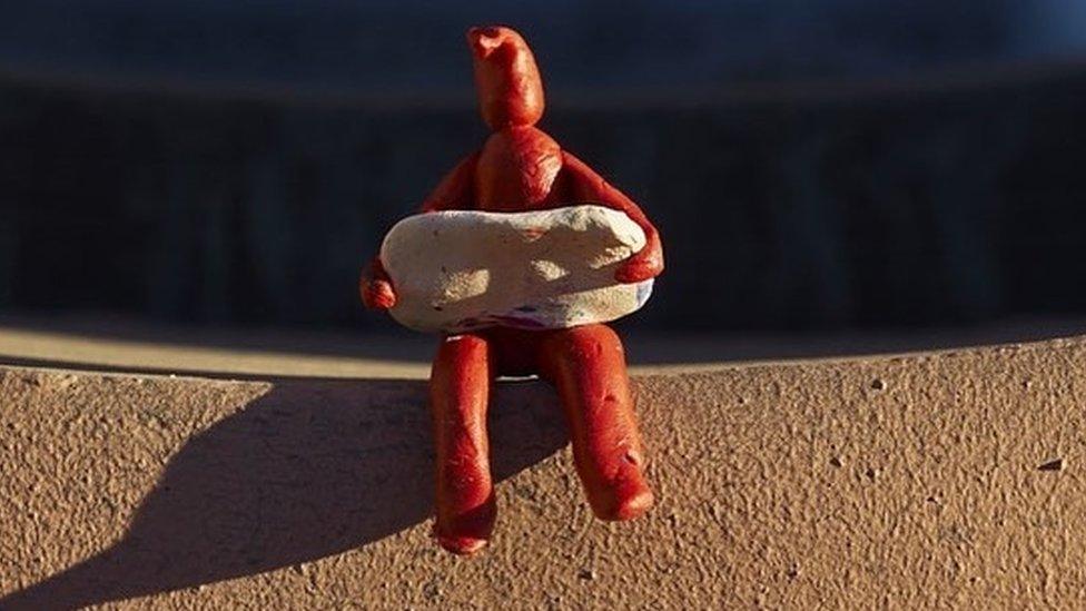 A red plasticine figure