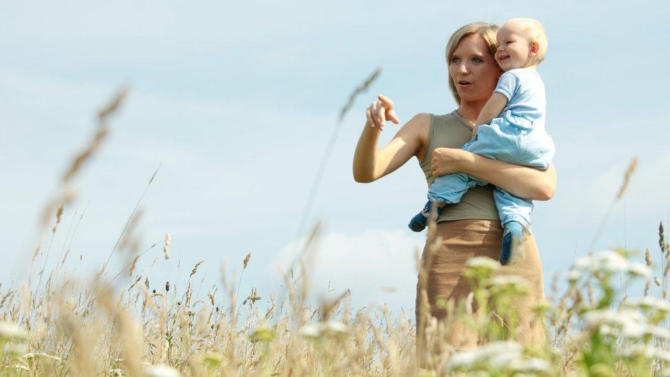 Mother and baby in countryside