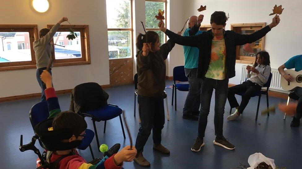 Children pretending to be trees in a theatre workshop