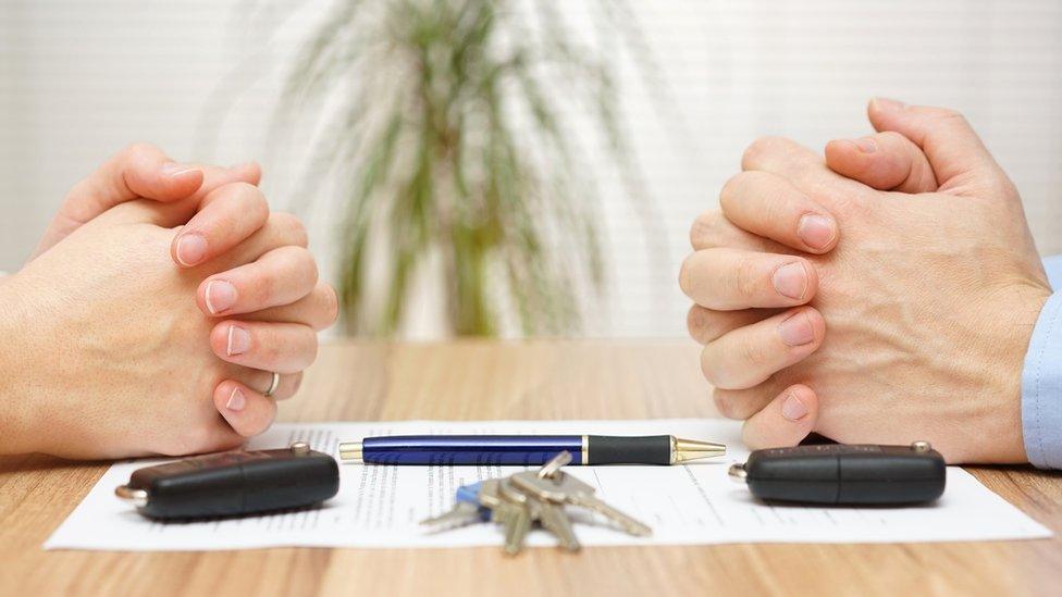 Hands and keys over divorce settlement