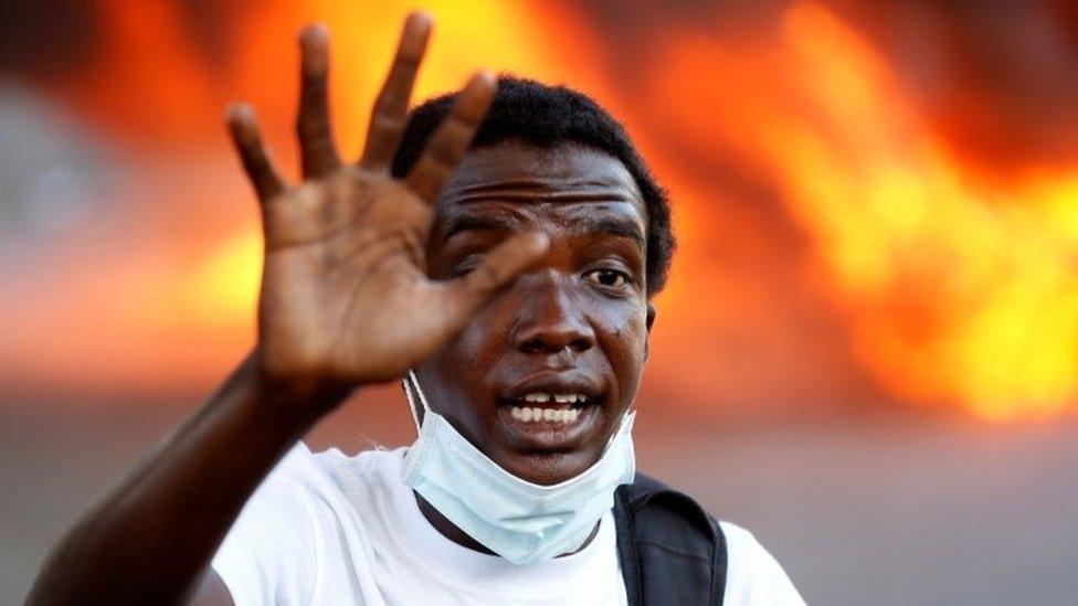 A demonstrator takes part in a march during a protest against Haiti's President Jovenel Moise, in Port-au-Prince, Haiti February 14, 2021.