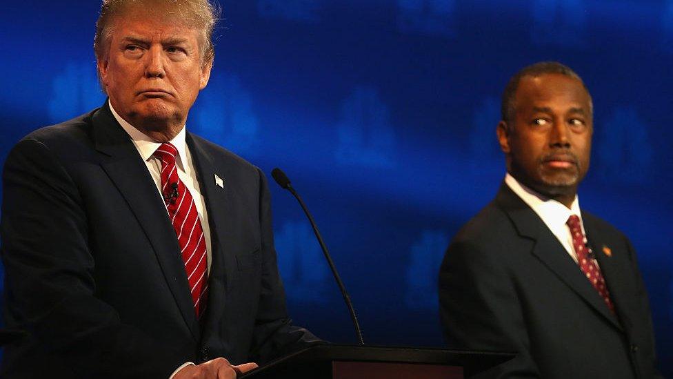 Presidential candidates Donald Trump (L) and Ben Carson look on during the CNBC Republican Presidential Debate