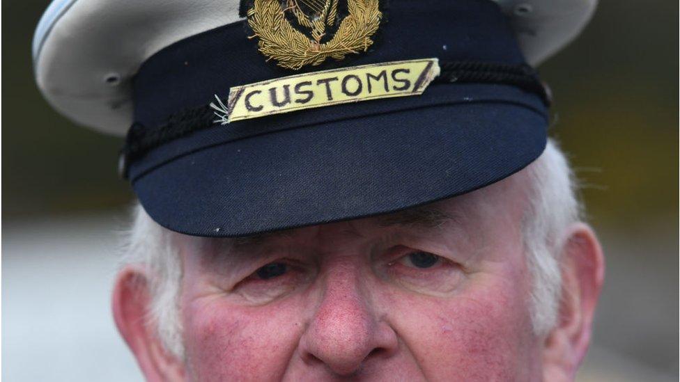 A mock customs officers stop cars at the border crossing between the Republic of Ireland and Northern Ireland