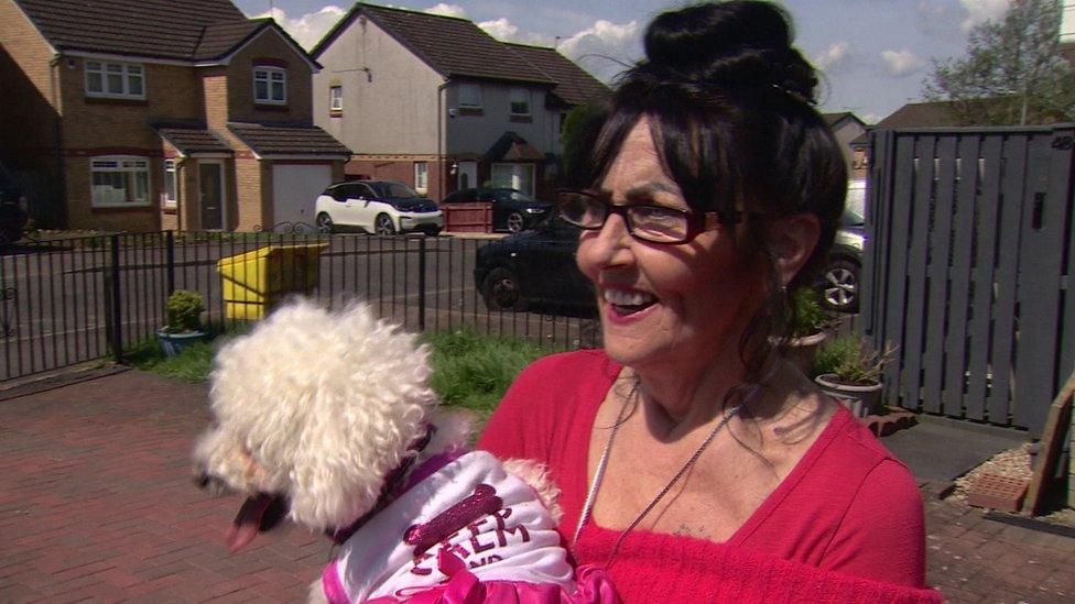 Isabella Roden holds Issy the dog