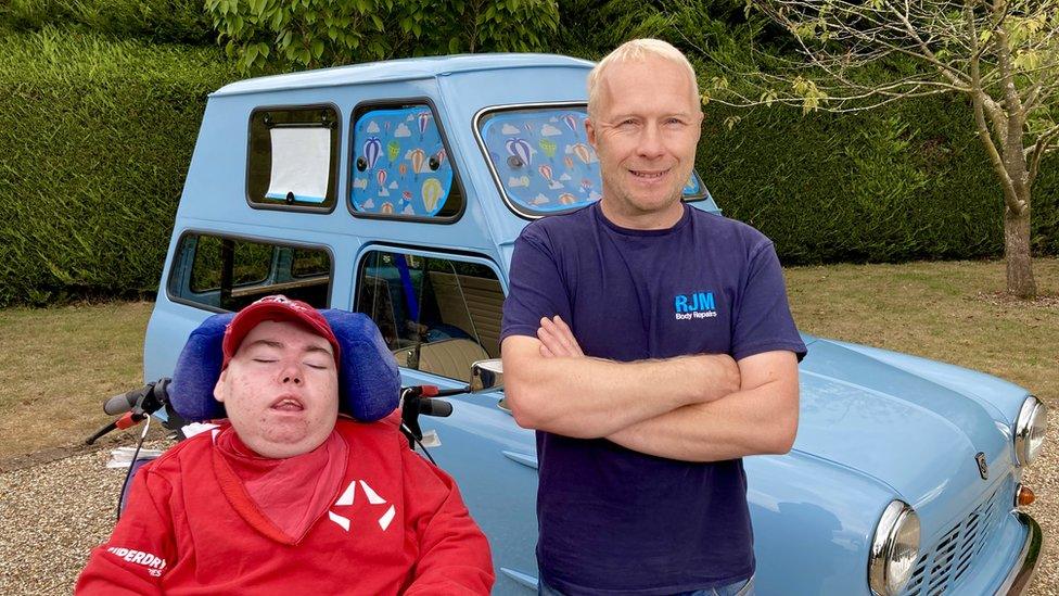 Robin Middleton and his son Charlie in front of the Pope mobile