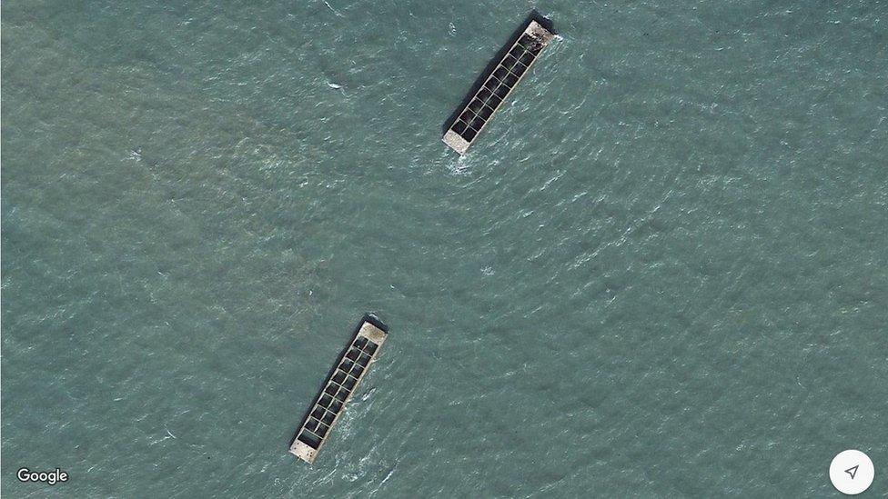 The remnants of the concrete breakwaters to protect the Mulberry Harbour at Arromanche