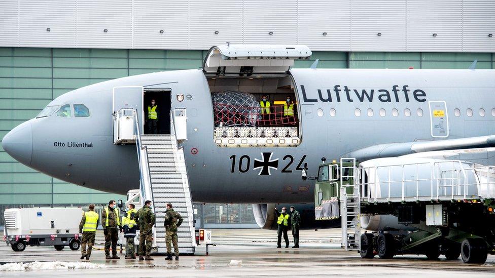 Staff of the German armed forces Bundeswehr stand around an Airbus A310-304 MRTT military transport plane of German armed forces Bundeswehr at the military airport in Wunstorf near Hanover, northwestern Germany, on February 3, 2021