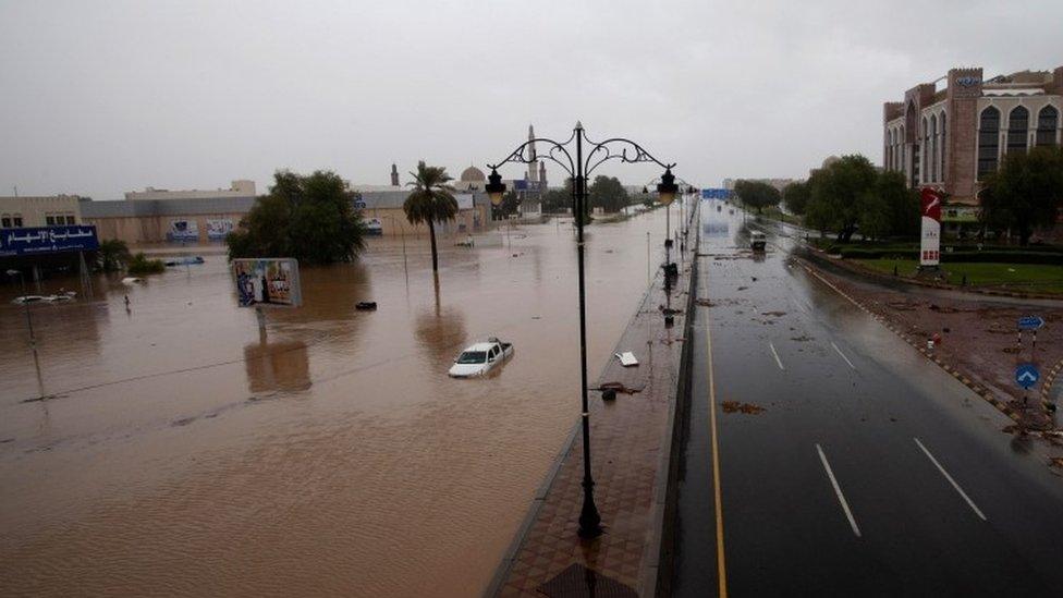 Cars are seen in flooded streets after Tropical Storm Shaheen hits the capital Muscat