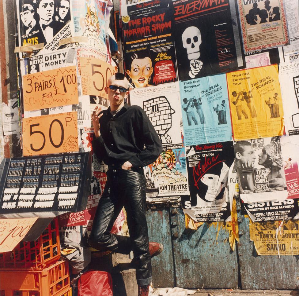 A punk selling 'Bad Earrings for Bad People' at a street stall in Camden, London, 1986