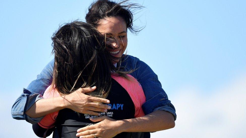 Meghan embraces a member of the NGO Waves for Change