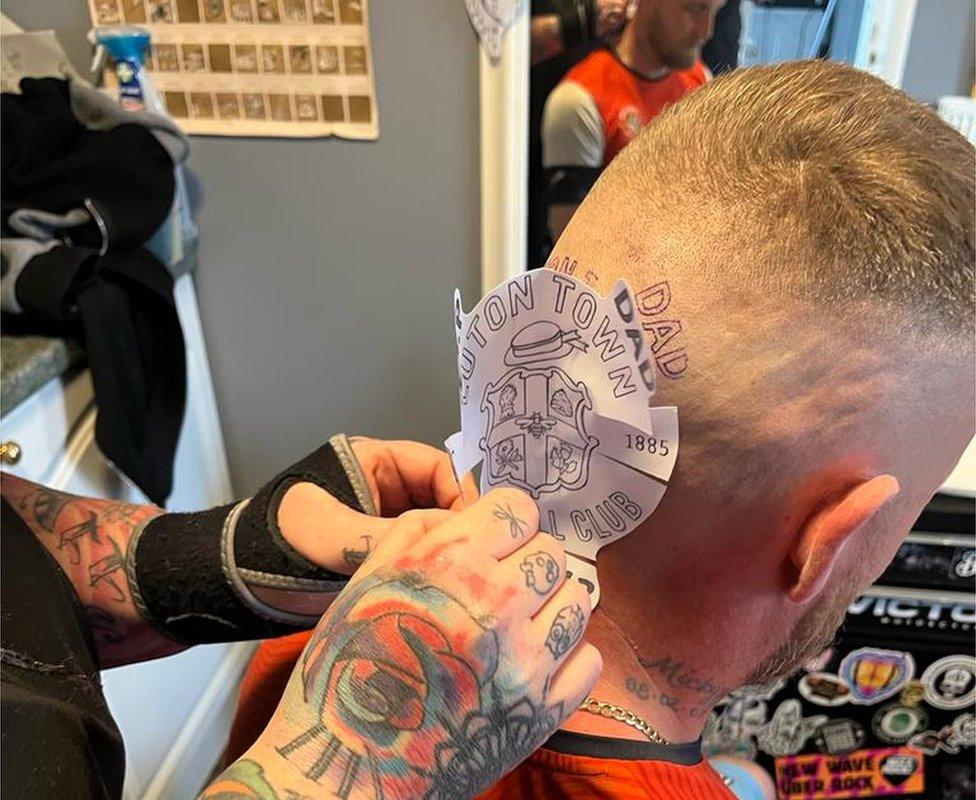 Micky receiving the Luton Town tattoo.