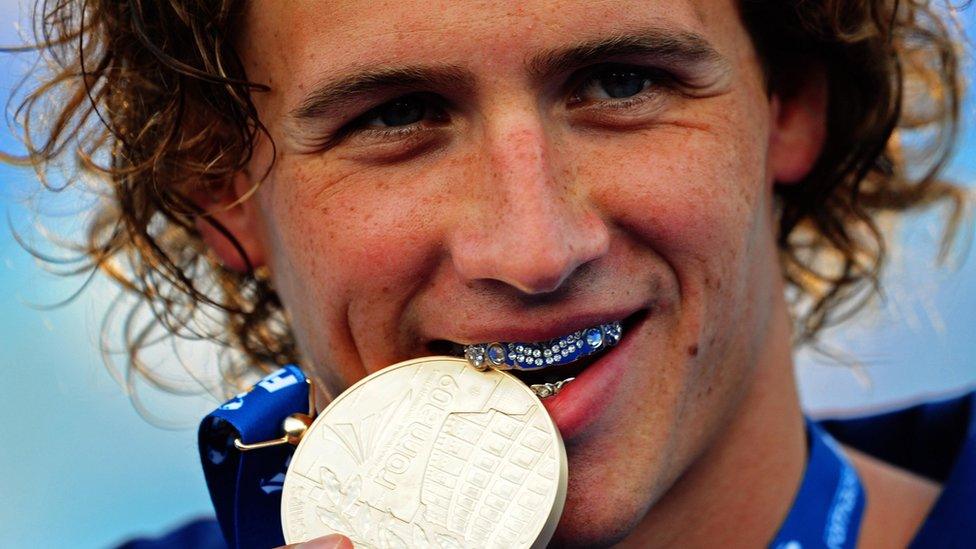 Lochte sports his patriotic grill while accepting a medal in 2009