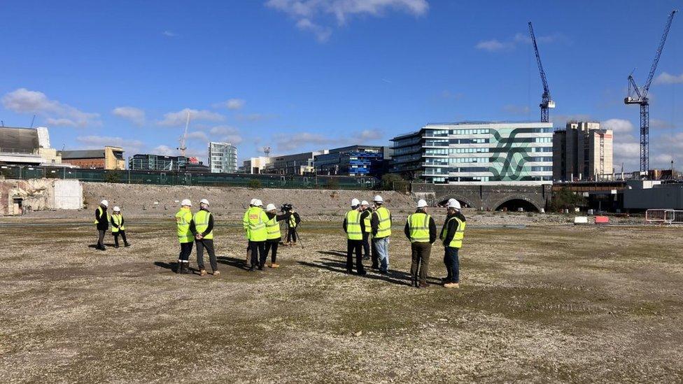 Workmen survey building site