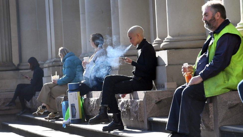 Workers sit socially distanced from each other outdoors on a lunch break in Melbourne's city centre on 19 June