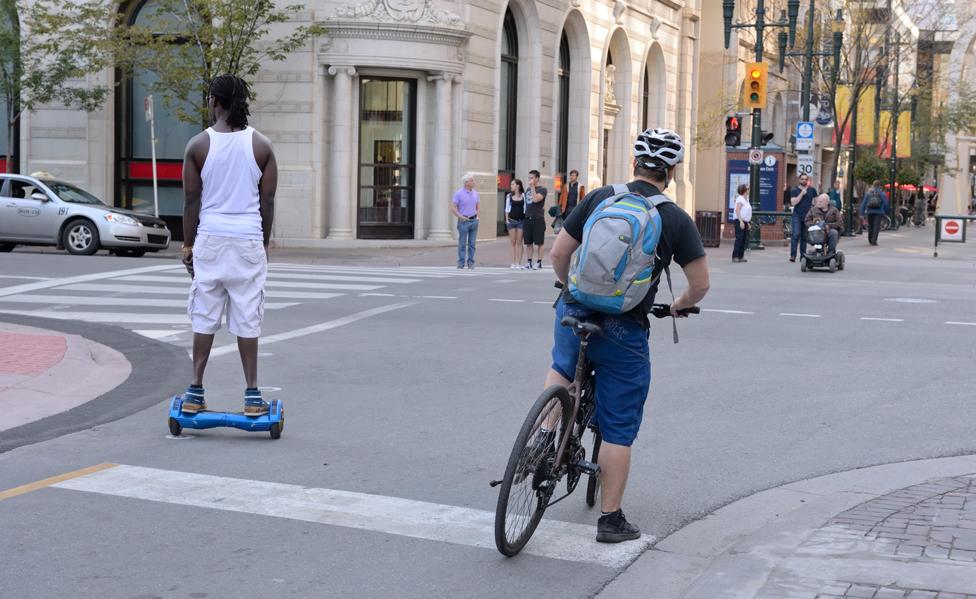 Man rides hoverboard on street in Calgary, Alberta