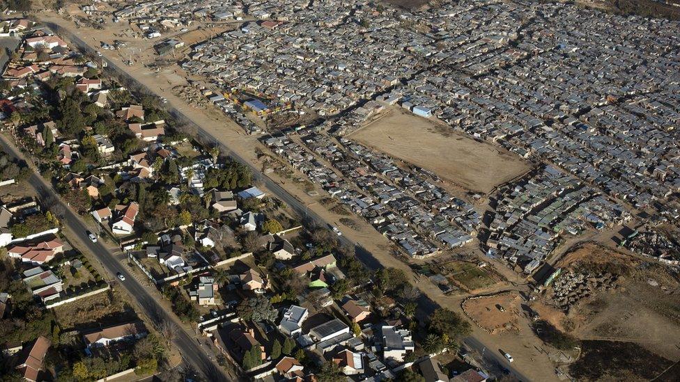 An aerial view of a poor squatter neighbourhood next to a rich one in Johannesburg