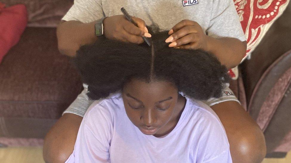 Keziah having her hair done.