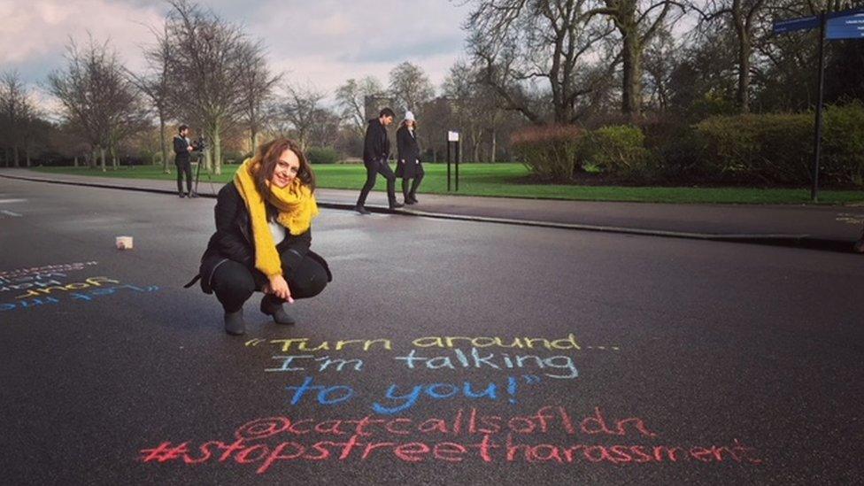 Farah next to a catcall written out on the ground