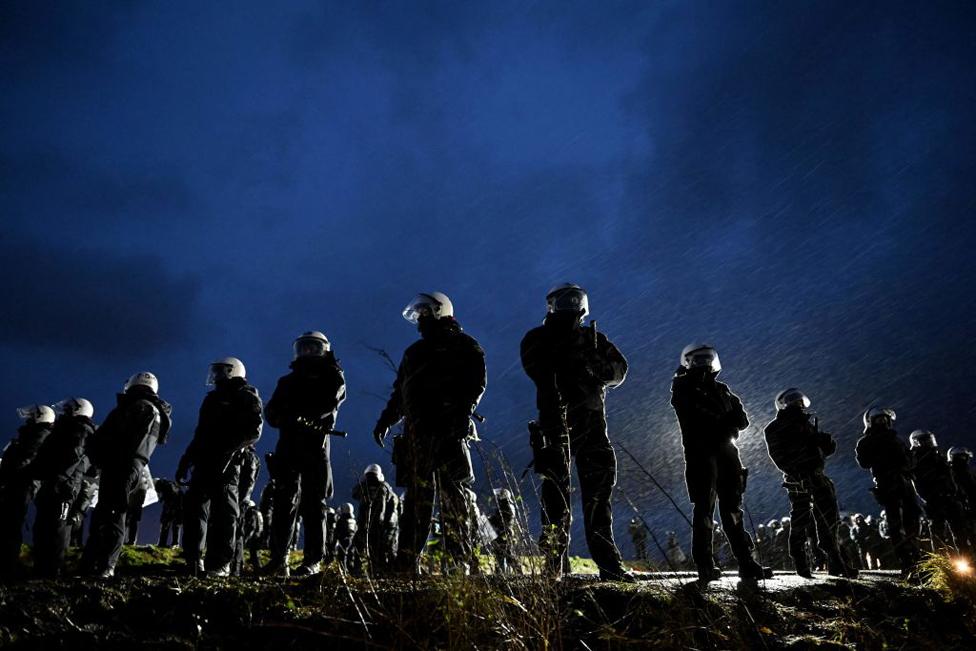 Police officers stand in the village of Luetzerath, western Germany, on 11 January 2023