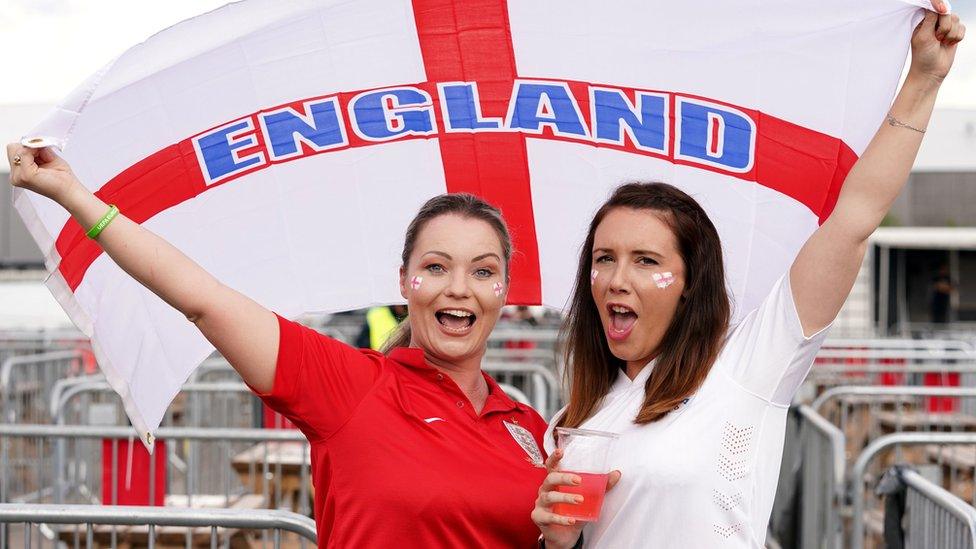 England fans in Manchester fly the national flag ahead of the match