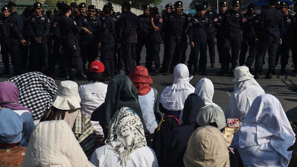 Supporters of Wat Dhammakaya pray before a police line in front of the temple just north of Bangkok, 16 February 2017