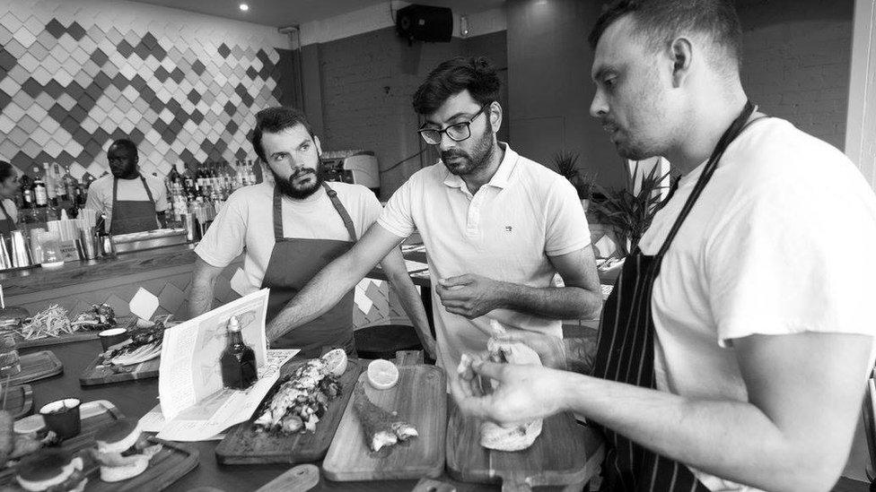 Aatkin Anadkat (middle) tasting food at The Fish and The Chip