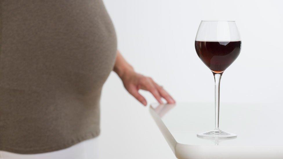 Pregnant woman with wine glass