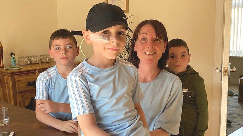 Oliver Maw (front) with his mum, Phillipa and brothers Oscar and Owen