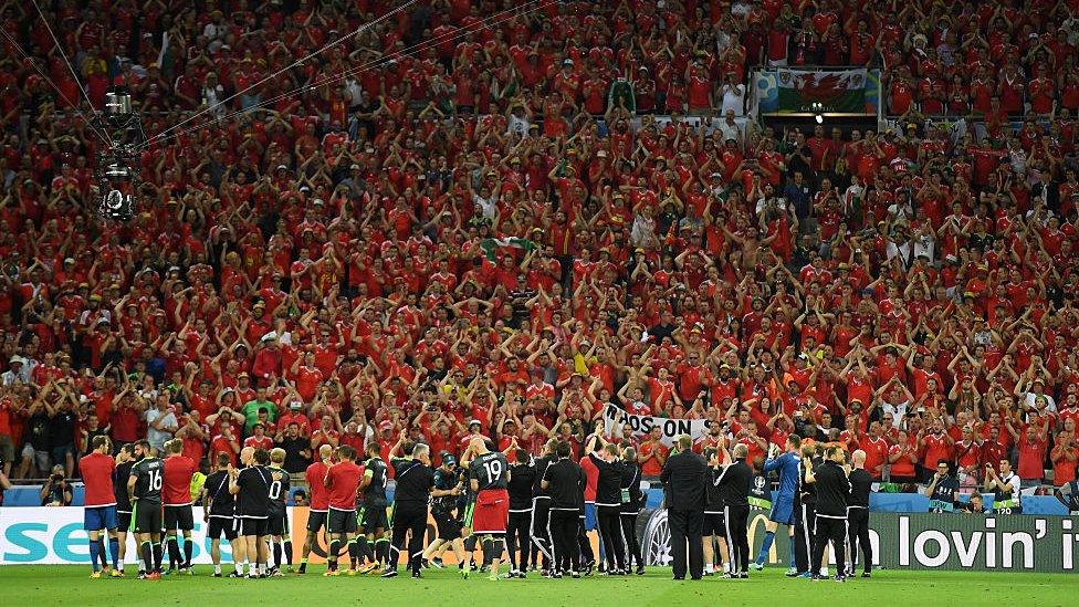 Fans applaud the Wales team after the game ends