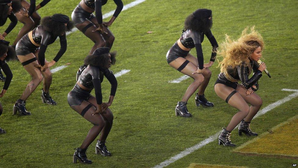 Beyonce on the pitch with her dancers