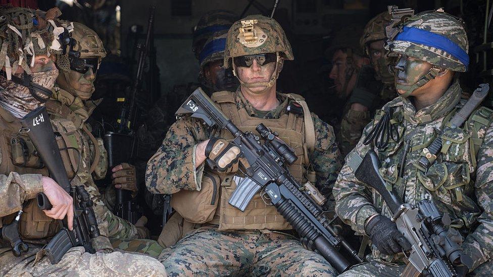 South Korean and US soldiers sit inside an amphibious vehicle as they pose for photographers during an annual joint military landing exercise