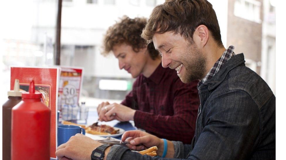 Friends eating together (stock image)