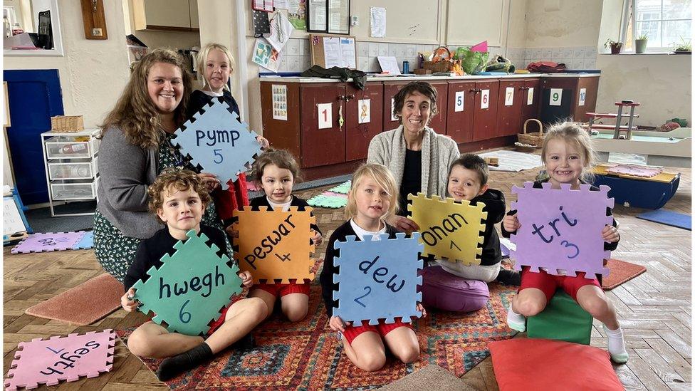 Teacher Abbie Richards with children at the nursery