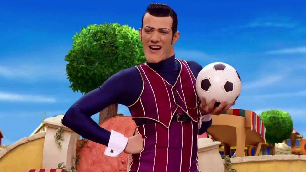 Robbie Rotten stands with a football