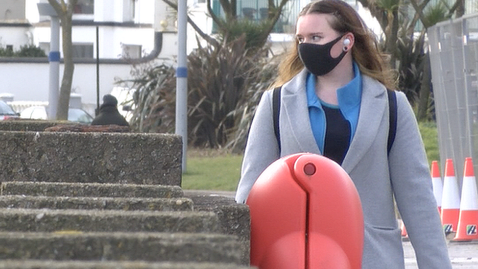 Woman walking along Douglas promenade