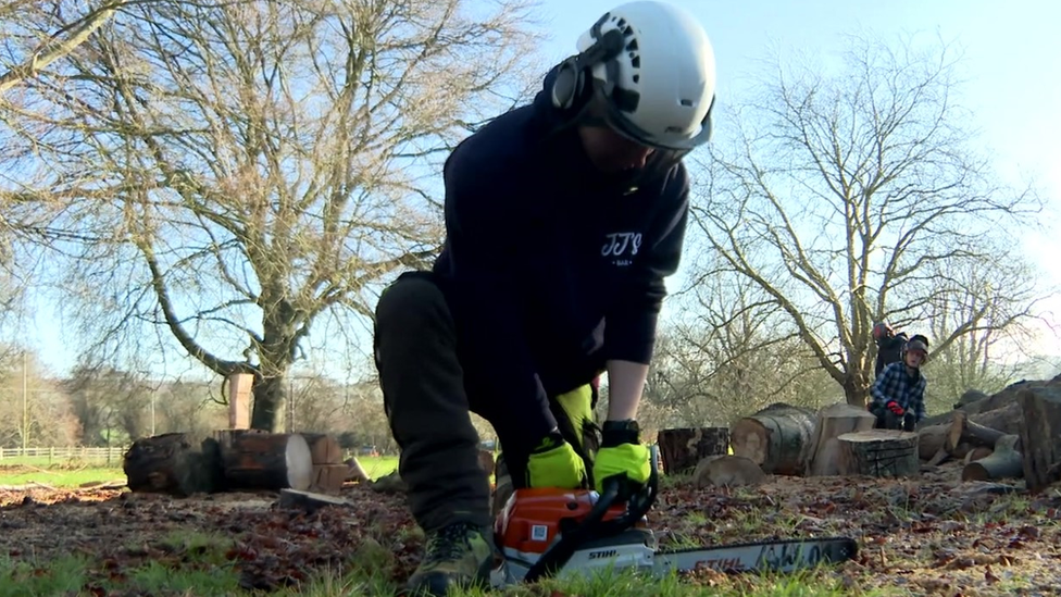 Student holding a chainsaw