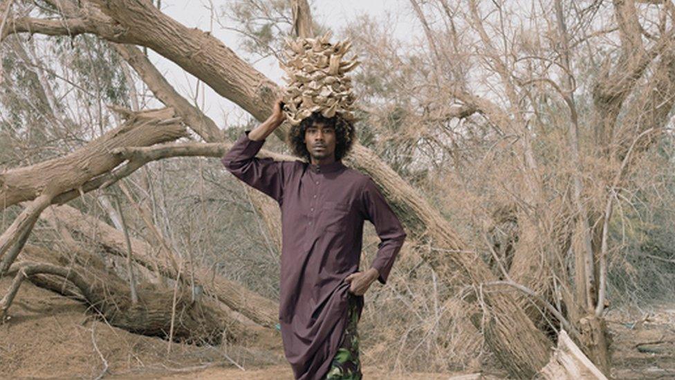 Portrait of a man standing by a tree