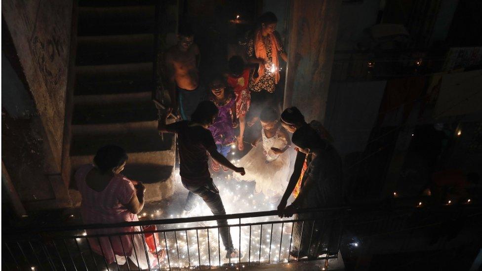 Indians play with firecrackers during Diwali festival in New Delhi, India, Sunday, Oct. 30, 2016.