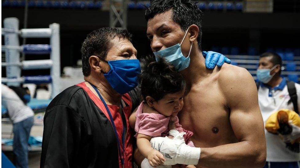 Zamora with his baby daughter