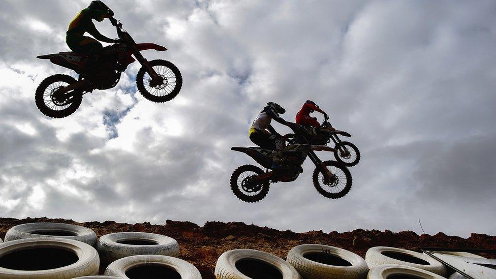 Motocross riders jumping over tyres in Cape Town, South Africa - Saturday 2 April 2016