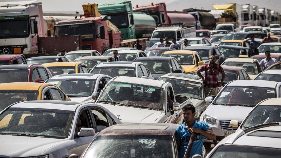 Traffic from Mosul queues at a Kurdish Check point in 2014 after Mosul was taken by IS