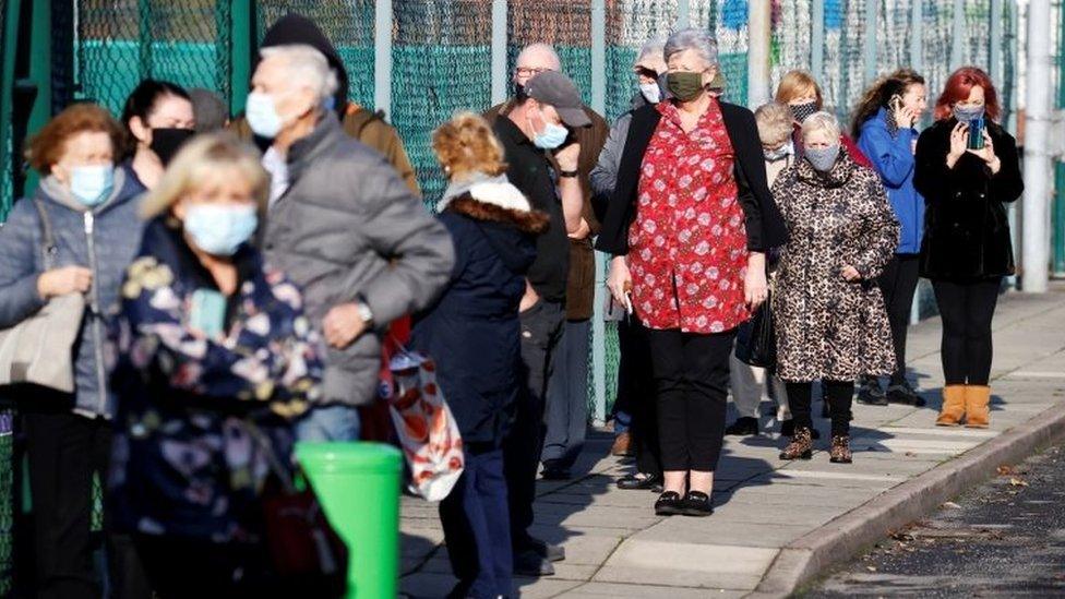 People queue at a coronavirus disease (Covid-19) testing centre in Liverpool on Friday