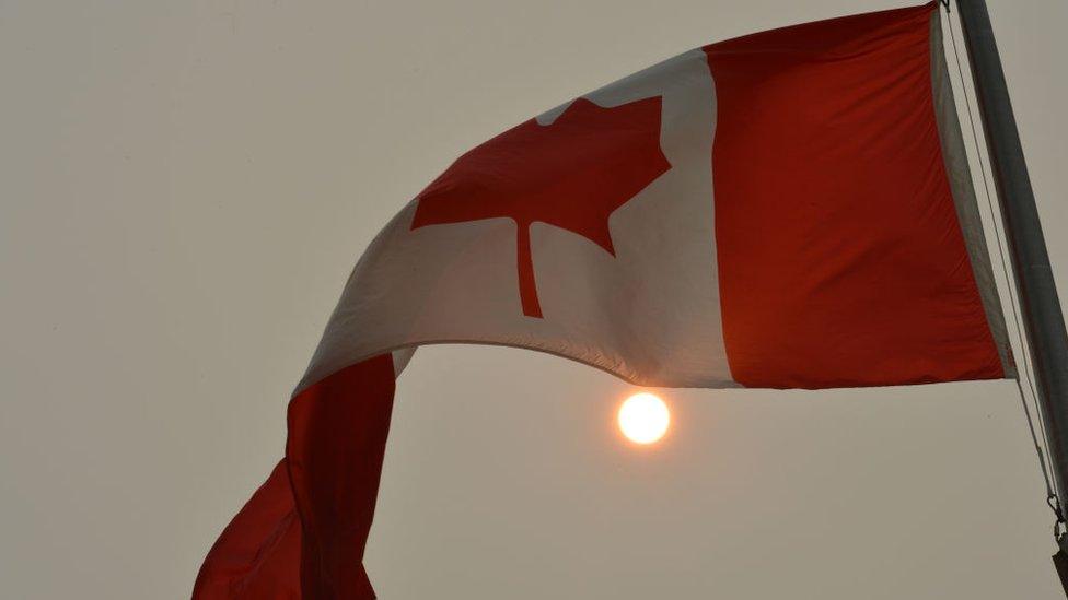 Canadian flag and hazy sun