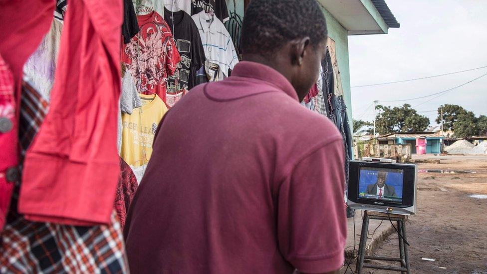 A man in Gabon watching a TV programme about the presidential election - August 2016